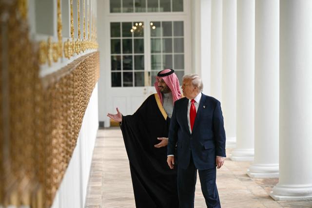 US President Donald Trump and Crown Prince and Prime Minister of the Kingdom of Saudi Arabia Mohammed bin Salman speaks as they walk down the Colonnade on the way to the Oval Office of the White House in Washington, DC on November 18, 2025. Saudi Crown Prince Mohammed bin Salman arrived at the White House to fanfare and a jet flyover Tuesday, in his first visit to the United States since the 2018 murder of journalist Jamal Khashoggi. (Photo by Brendan SMIALOWSKI / AFP)