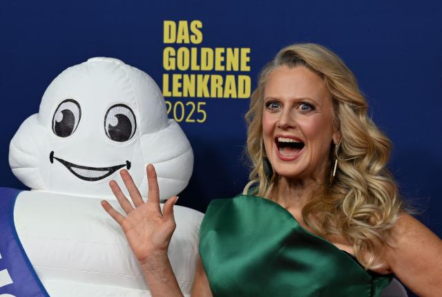 TV host Barbara Schoeneberger poses on the red carpet upon arrival for the "Goldenes Lenkrad" (Golden Steering Wheel) awards on November 18, 2025 in Berlin. (Photo by RALF HIRSCHBERGER / AFP)