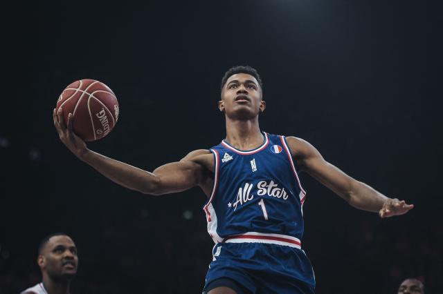 (FILES) France's Theo Maledon on his way to score a point during an All Star Game basketball match of the French Ligue Nationale de Basket (LNB) between a selection of the best international players from the Pro A league against a selection of the best French players, at the AccorHotels Arena, in Paris on December 29, 2018. The French point guard, whose spectacular rebounding with ASVEL last season opened the doors to Real Madrid, the EuroLeague giant, told AFP that he has "rediscovered the joy of playing" after a difficult NBA experience with Oklahoma City, Charlotte, and Phoenix. (Photo by Lucas BARIOULET / AFP)