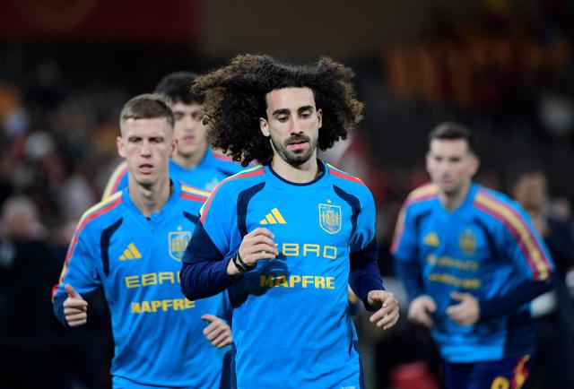 Spain's defender #22 Marc Cucurella and teammates warm up prior the FIFA World Cup 2026 European qualification Group E football match between Spain and Turkey at the Cartuja stadium in Seville on November 18, 2025.  (Photo by CRISTINA QUICLER / AFP)