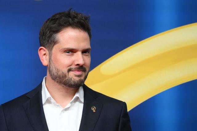 CEO of TESLA Germany, Simon Zwahlen poses on the red carpet upon arrival for the "Goldenes Lenkrad" (Golden Steering Wheel) awards on November 18, 2025 in Berlin. (Photo by RALF HIRSCHBERGER / AFP)