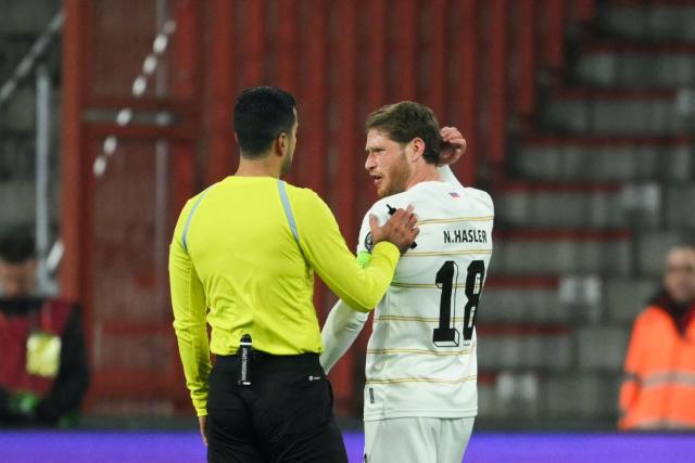 Liechtenstein's midfielder #18 Nicolas Hasler speaks to the referee during the FIFA World Cup 2026 Group J European qualification football match between Belgium and Liechtenstein at the Maurice-Dufrasne stadium, in Liege, on November 18, 2025. (Photo by NICOLAS TUCAT / AFP)