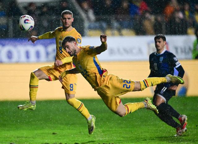 Romania's midfielder #22 Vlad Dragomir heads the ball during the FIFA World Cup 2026 European qualification Group H football match between Romania and San Marino, in Bucharest, on November 18, 2025. (Photo by Daniel MIHAILESCU / AFP)