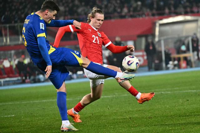 Bosnia-Herzegovina's midfielder #06 Benjamin Tahirovic and Austria's midfielder #21 Patrick Wimmer vie for the ball during the FIFA World Cup 2026 European qualification Group H football match between Austria and Bosnia and Herzegovina, in Vienna on November 18, 2025. (Photo by Joe Klamar / AFP)