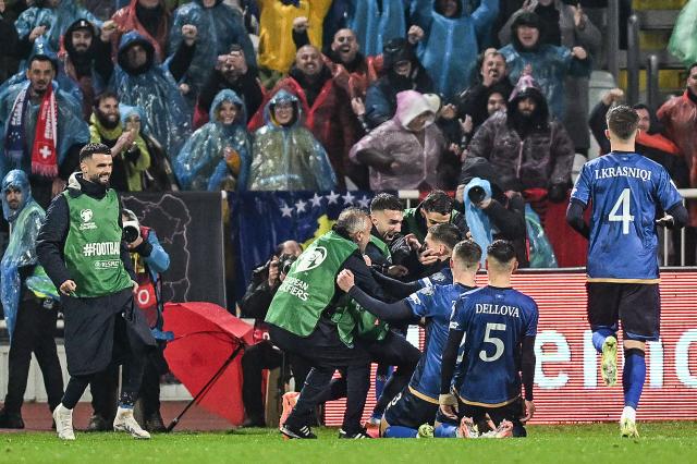 Kosovo's midfielder #08 Florent Muslija (C) celebrates with teammates and supporters  after scoring  his team's first goal  during the FIFA World Cup 2026 European qualification Group B football between Kosovo and Switzerland at the Fadil Vokrri Stadium in Pristina, on November 18, 2025. (Photo by Armend NIMANI / AFP)