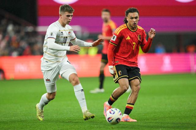 Belgium's defender #07 Diego Moreira fights for the ball with Liechtenstein's midfielder #10 Alessio Hasler during the FIFA World Cup 2026 Group J European qualification football match between Belgium and Liechtenstein at the Maurice-Dufrasne stadium, in Liege, on November 18, 2025. (Photo by NICOLAS TUCAT / AFP)