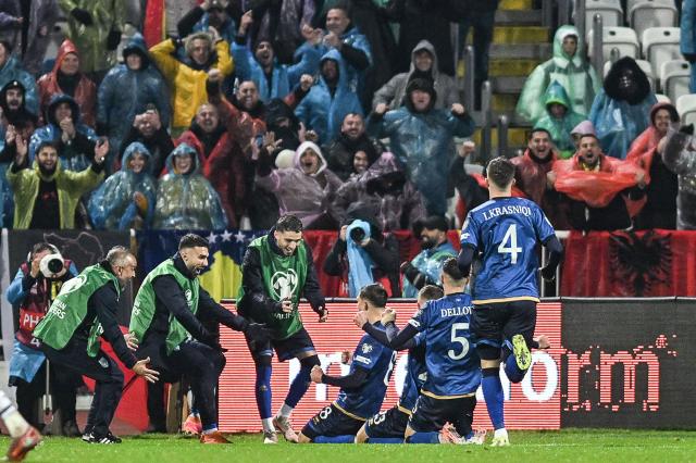 Kosovo's midfielder #08 Florent Muslija (C) celebrates with teammates and supporters  after scoring  his team's first goal  during the FIFA World Cup 2026 European qualification Group B football between Kosovo and Switzerland at the Fadil Vokrri Stadium in Pristina, on November 18, 2025. (Photo by Armend NIMANI / AFP)