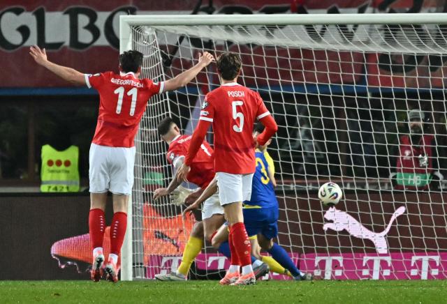 Austria's forward #11 Michael Gregoritsch (L) celebrates scoring the equalizer during the FIFA World Cup 2026 European qualification Group H football match between Austria and Bosnia and Herzegovina, in Vienna on November 18, 2025. (Photo by Joe Klamar / AFP)