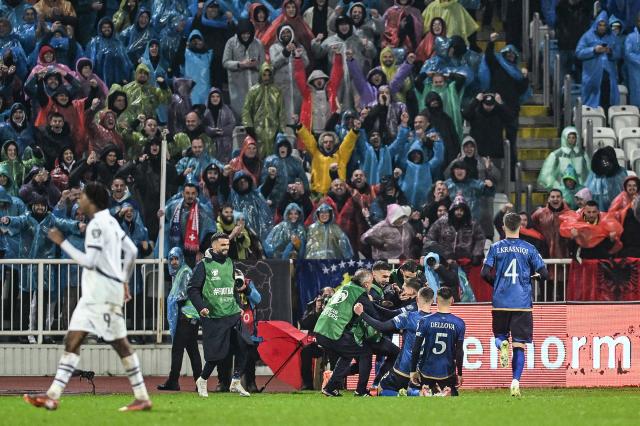 Kosovo's midfielder #08 Florent Muslija (C) celebrates with teammates and supporters  after scoring  his team's first goal  during the FIFA World Cup 2026 European qualification Group B football between Kosovo and Switzerland at the Fadil Vokrri Stadium in Pristina, on November 18, 2025. (Photo by Armend NIMANI / AFP)