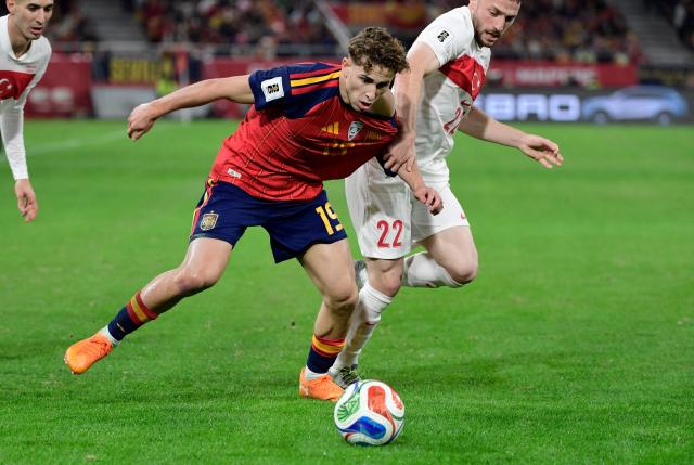 Spain's forward #19 Fermin Lopez fights for the ball with Turkey's defender #22 Mustafa Eskihellac during the FIFA World Cup 2026 European qualification Group E football match between Spain and Turkey at the Cartuja stadium in Seville on November 18, 2025.  (Photo by CRISTINA QUICLER / AFP)