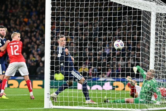 Scotland's striker #20 Lawrence Shankland (C) scores their second goal during the FIFA World Cup 2026 European qualification football match between Scotland and Denmark at Hampden Park in Glasgow on November 18, 2025.  (Photo by ANDY BUCHANAN / AFP)