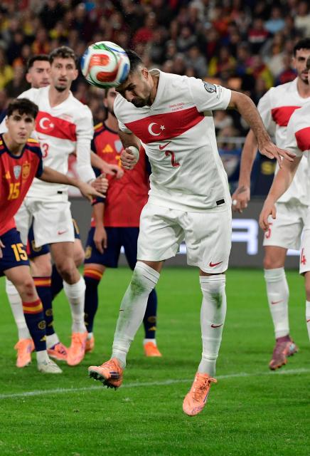Turkey's defender #02 Zeki Celik heads the ball during the FIFA World Cup 2026 European qualification Group E football match between Spain and Turkey at the Cartuja stadium in Seville on November 18, 2025.  (Photo by CRISTINA QUICLER / AFP)