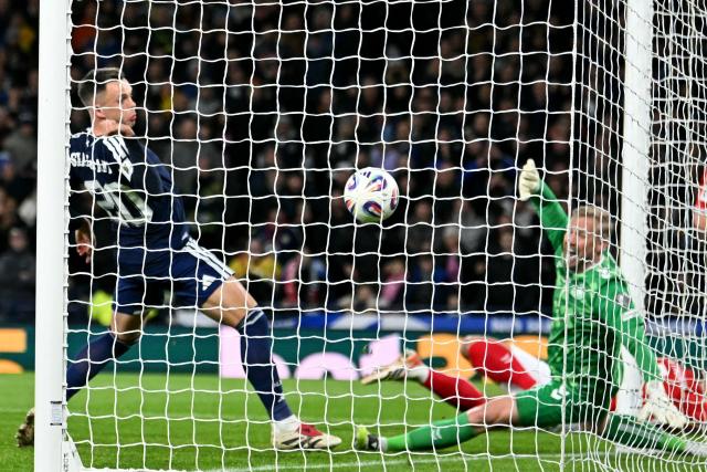 Scotland's striker #20 Lawrence Shankland (L) scores their second goal during the FIFA World Cup 2026 European qualification football match between Scotland and Denmark at Hampden Park in Glasgow on November 18, 2025.  (Photo by ANDY BUCHANAN / AFP)