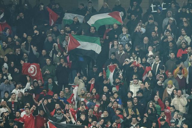 Supporters hold Palestinian flags in the stands during the International friendly football match between Brazil and Tunisia at Stade Pierre-Mauroy, in Villeneuve-d'Ascq, northern France, on November 18, 2025. (Photo by Sameer Al-DOUMY / AFP)