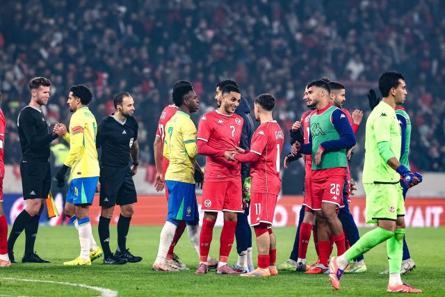 Tunisia's and Brazil's players greet each other at the end of the International friendly football match between Brazil and Tunisia at Stade Pierre-Mauroy, in Villeneuve-d'Ascq, northern France, on November 18, 2025. (Photo by Sameer Al-DOUMY / AFP)
