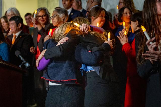 Victims of convicted sex offender Jeffrey Epstein share a hug after learning that the US Senate passed the "Epstein Files Transparency Act" while participating in a candlelight vigil to honor survivors of his crimes in Washington, DC on November 18, 2025. The US Senate on Tuesday approved a House-passed bill ordering the release of federal files on Jeffrey Epstein, the disgraced financier whose extensive alleged sex trafficking network fueled one of the country's most incendiary scandals. (Photo by DANIEL HEUER / AFP)