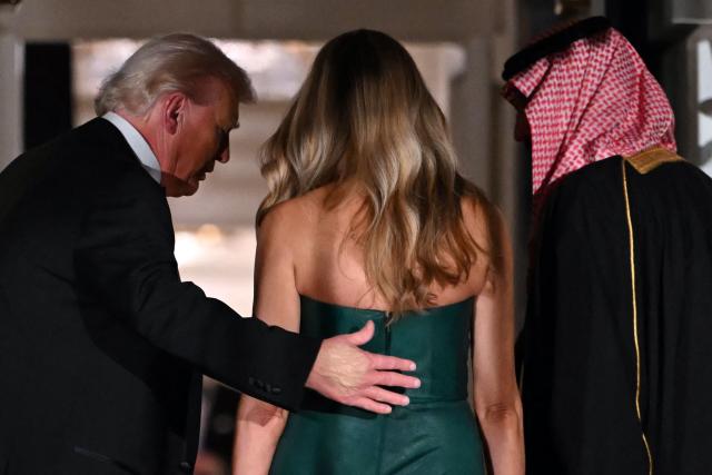 The Crown Prince and Prime Minister of the Kingdom of Saudi Arabia Mohammed bin Salman (R) is welcomed by US President Donald Trump and First Lady Melania Trump to attend a state dinner at the White House in Washington, DC on November 18, 2025. (Photo by ANDREW CABALLERO-REYNOLDS / AFP)