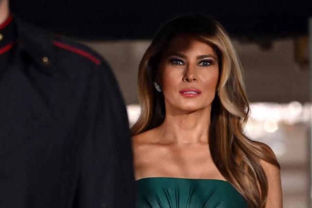 US First Lady Melania Trump, accompanied by President Donald Trump, waits for the arrival of the Crown Prince and Prime Minister of the Kingdom of Saudi Arabia Mohammed bin Salman prior to a state dinner at the White House in Washington, DC on November 18, 2025. (Photo by ANDREW CABALLERO-REYNOLDS / AFP)