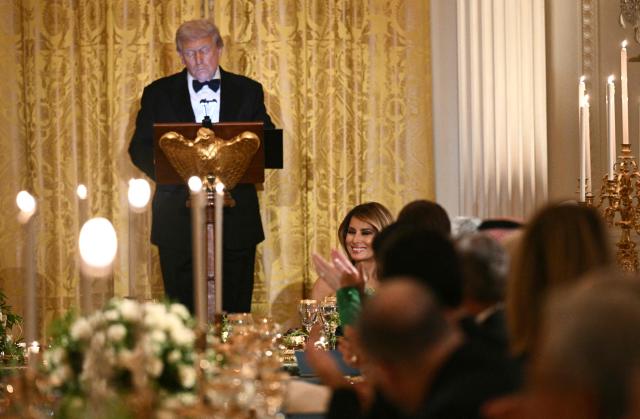 US First Lady Melania Trump smiles as US President Donald Trump speaks during an official dinner with Crown Prince and Prime Minister of the Kingdom of Saudi Arabia Mohammed bin Salman in the East Room of the White House in Washington, DC on November 18, 2025. (Photo by Brendan SMIALOWSKI / AFP)