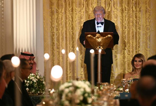 US First Lady Melania Trump (R) listens to US President Donald Trump speak during an official dinner with Crown Prince and Prime Minister of the Kingdom of Saudi Arabia Mohammed bin Salman (L) in the East Room of the White House in Washington, DC on November 18, 2025. (Photo by Brendan SMIALOWSKI / AFP)