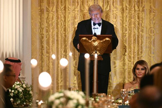US First Lady Melania Trump (R) listens to US President Donald Trump speak during an official dinner with Crown Prince and Prime Minister of the Kingdom of Saudi Arabia Mohammed bin Salman (L) in the East Room of the White House in Washington, DC on November 18, 2025. (Photo by Brendan SMIALOWSKI / AFP)
