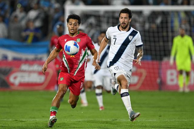 Suriname's midfielder #10 Denzel Jubitana and Guatemala's defender #07 Aaron Herrera fight for the ball during the 2026 FIFA World Cup Concacaf qualifier football match between Guatemala and Suriname at the Manuel Felipe Carrera stadium in Guatemala City on November 18, 2025. (Photo by JOHAN ORDONEZ / AFP)