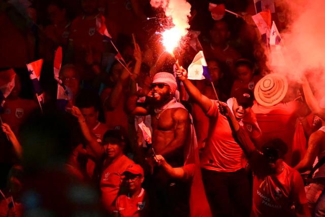 Panama fans lit red flares as they cheer during the 2026 FIFA World Cup Concacaf qualifier football match between Panama and El Salvador at the Rommel Fernandez Stadium in Panama City on November 18, 2025. (Photo by MARTIN BERNETTI / AFP)