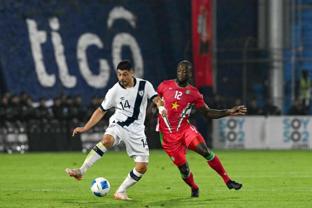 Guatemala's forward #14 Darwin Lom and Suriname's defender #02 Myenty Abena fight for the ball during the 2026 FIFA World Cup Concacaf qualifier football match between Guatemala and Suriname at the Manuel Felipe Carrera stadium in Guatemala City on November 18, 2025. (Photo by JOHAN ORDONEZ / AFP)