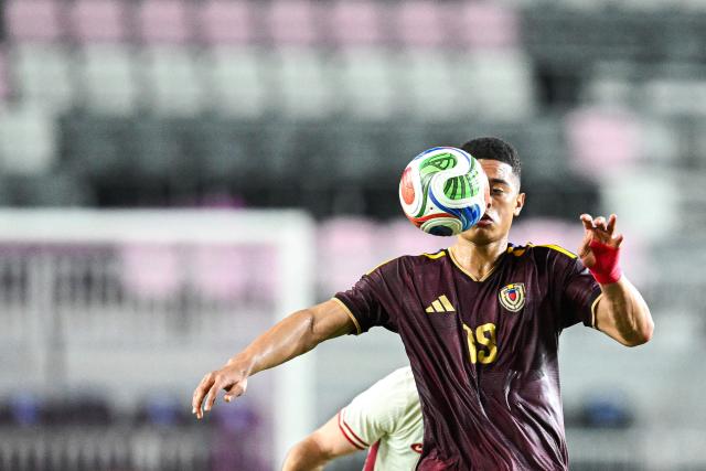Venezuela's forward #19 Kevin Kelsy kicks the ball during the international friendly football match between Canada and Venezuela at Chase Stadium in Fort Lauderdale, Florida, on November 18, 2025. (Photo by CHANDAN KHANNA / AFP)