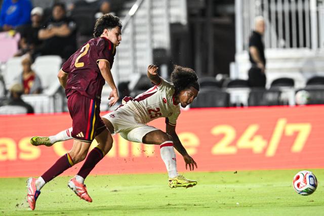 Venezuela's defender #02 Nahuel Ferraresi and Canada's forward #25 Jayden Nelson fight for the ball during the international friendly football match between Canada and Venezuela at Chase Stadium in Fort Lauderdale, Florida, on November 18, 2025. (Photo by CHANDAN KHANNA / AFP)
