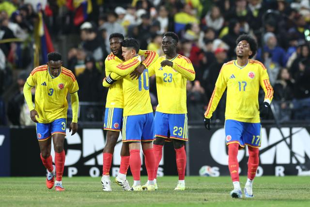 Colombia’s players celebrate after winning the international friendly football match against Australia at Citifield stadium in the Queens borough of New York City on November 18, 2025. (Photo by CHARLY TRIBALLEAU / AFP)