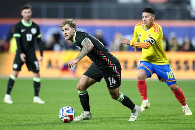 Australia’s midfielder #14 Riley McGree fights for the ball with Colombia’s Midfielder #10 James Rodriguez during the international friendly football match between Colombia and Australia at Citifield stadium in the Queens borough of New York City on November 18, 2025. (Photo by CHARLY TRIBALLEAU / AFP)