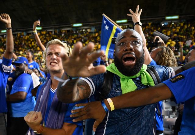 Curaçao fans celebrate World Cup 2026 qualification after a 0-0 draw with Jamaica at the National Stadium in Kingston, Jamaica on November 18, 2025. The tiny Caribbean nation of Curacao became the smallest country ever to qualify for the World Cup on November 18 as Haiti booked their return to the tournament for the first time in 52 years along with Panama.
A nerve-shredding finale to the CONCACAF qualifying campaign saw Curacao -- with a population of just 156,000 -- squeeze into next year's finals in the United States, Canada and Mexico with a 0-0 draw against Jamaica in Kingston. (Photo by Ricardo MAKYN / AFP)