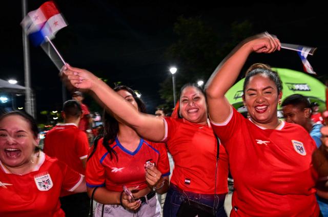 Panamanians celebrate after Panama qualified for the 2026 FIFA World Cup in Panama City on November 18, 2025. (Photo by MARTIN BERNETTI / AFP)