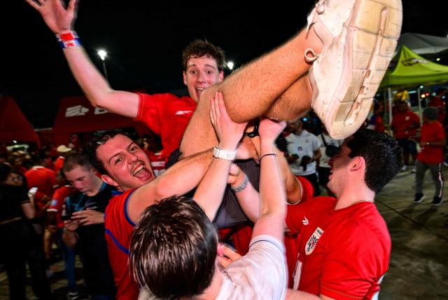Panamanians celebrate after Panama qualified for the 2026 FIFA World Cup in Panama City on November 18, 2025. (Photo by MARTIN BERNETTI / AFP)