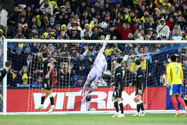 Australia’s goalkeeper #12 Paul Izzo saves the ball during the international friendly football match between Colombia and Australia at Citifield stadium in the Queens borough of New York City on November 18, 2025. (Photo by CHARLY TRIBALLEAU / AFP)