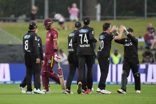 West Indies' Roston Chase (back L) walks from the field after being bowled as New Zealand players celebrate during the second one-day international cricket match between New Zealand and the West Indies at McLean Park in Napier on November 19, 2025. (Photo by Marty MELVILLE / AFP)
