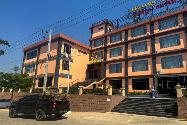 (FILES) Members of the Karen Border Guard Force (BGF) patrol during a crackdown operation on illicit activity linked to scam centres in Shwe Kokko in Myanmar's eastern Myawaddy township on February 14, 2025. Myanmar's military said it raided the internet scam hub of Shwe Kokko on the Thai border, arresting nearly 350 people, part of a highly publicised crackdown against the booming black market compounds. (Photo by AFP)