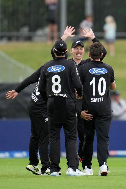 New Zealand's Michael Bracewell (C) celebrates West Indies's Roston Chase being bowed with teammates Rachin Ravindra and Nathan Smith (R) during the second one-day international cricket match between New Zealand and the West Indies at McLean Park in Napier on November 19, 2025. (Photo by Marty MELVILLE / AFP)