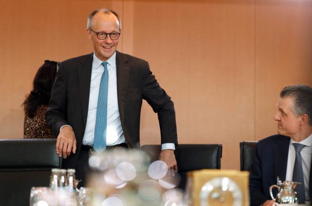 Chief of Staff and Minister for Special Tasks Thorsten Frei (R) looks on as German Chancellor Friedrich Merz arrives for the weekly meeting of the German cabinet at the Chancellery in Berlin on November 19, 2025. (Photo by Odd ANDERSEN / AFP)