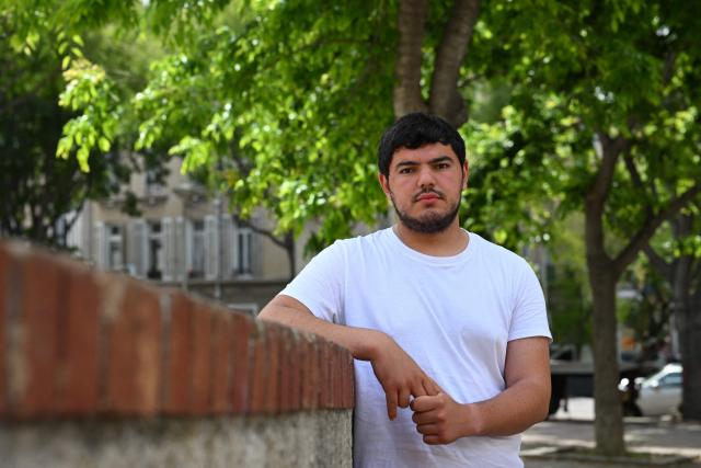 (FILES) France's The Ecologists political party's candidate for the upcoming European elections, Amine Kessaci poses in Marseille, southeastern France, on May 27, 2024. "No, I will not remain silent" in the face of drug trafficking, said Amine Kessaci, the brother of Mehdi, who was shot dead on November 13, 2025, in Marseille by two people on a motorbike, in an opinion piece published on November 19, 2025, in the newspaper Le Monde. "I will say and repeat that my brother Mehdi died for nothing. I will speak out about the violence of drug trafficking," wrote the 22-year-old environmental activist, who was involved in the fight against drug-related crime. In 2020, this family of six children had already been bereaved by the murder of another of their brothers, Brahim, 22, whose body was found charred in a vehicle. (Photo by Nicolas TUCAT / AFP)