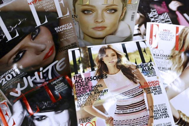 (FILES) Covers of some of the 42 foreign editions of the French fashion magazine "Elle", owned by French media conglomerate Lagardere, are displayed in Paris on January 4, 2011. Sometimes jostled, always eagerly read by all ages, Elle magazine, now celebrating its 80th anniversary, has followed the history of women and intends to remain a ‘mirror’ and a ‘catalyst’ for society. (Photo by Joлl SAGET / AFP)
