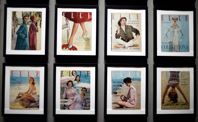 (FILES) Elle Magazine are displayed at the Palais Galliera  as part of an exhibition on French fashion between 1947 and 1957, in Paris on July 10, 2014. Sometimes jostled, always eagerly read by all ages, Elle magazine, now celebrating its 80th anniversary, has followed the history of women and intends to remain a ‘mirror’ and a ‘catalyst’ for society. (Photo by STEPHANE DE SAKUTIN / AFP)