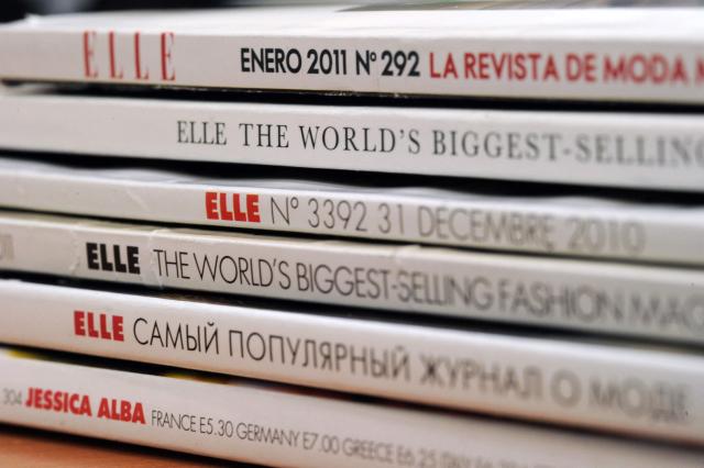 (FILES) Some of the 42 foreign editions of the French fashion magazine "Elle", owned by French media conglomerate Lagardere, are displayed in Paris on January 4, 2011. Sometimes jostled, always eagerly read by all ages, Elle magazine, now celebrating its 80th anniversary, has followed the history of women and intends to remain a ‘mirror’ and a ‘catalyst’ for society. (Photo by Miguel MEDINA / AFP)