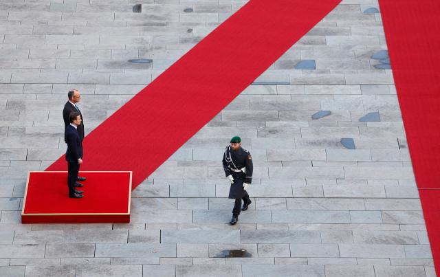 German Chancellor Friedrich Merz (L, behind) and Sweden's Prime Minister Ulf Kristersson (L, front) review a military honor guard in front of the Chancellery in Berlin on November 19, 2025. (Photo by Odd ANDERSEN / AFP)