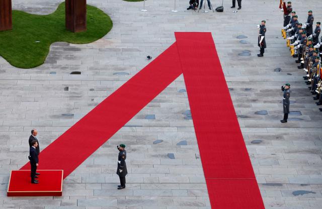German Chancellor Friedrich Merz (L, behind) and Sweden's Prime Minister Ulf Kristersson (L, front) review a military honor guard in front of the Chancellery in Berlin on November 19, 2025. (Photo by Odd ANDERSEN / AFP)