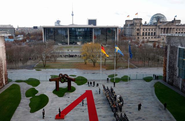 German Chancellor Friedrich Merz and Sweden's Prime Minister Ulf Kristersson review a military honor guard in front of the Chancellery in Berlin on November 19, 2025. (Photo by Odd ANDERSEN / AFP)