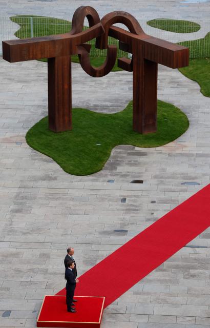 German Chancellor Friedrich Merz (behind) and Sweden's Prime Minister Ulf Kristersson (front) review a military honor guard in front of the Chancellery in Berlin on November 19, 2025. (Photo by Odd ANDERSEN / POOL / AFP)