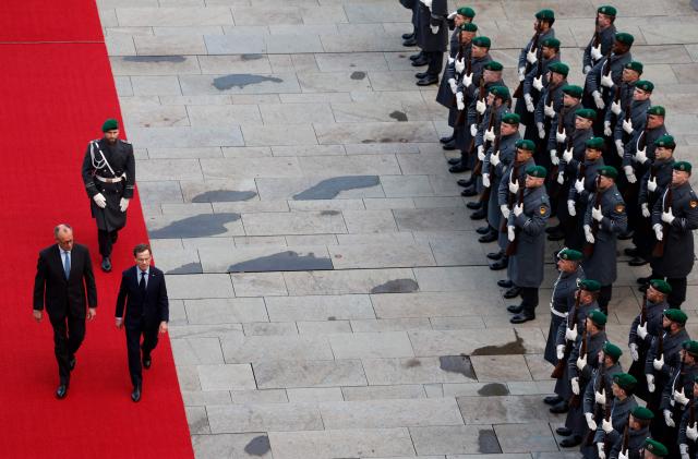 German Chancellor Friedrich Merz (L) and Sweden's Prime Minister Ulf Kristersson review a military honor guard in front of the Chancellery in Berlin on November 19, 2025. (Photo by Odd ANDERSEN / AFP)