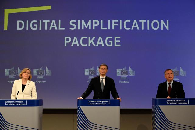 (LtoR) EU Executive Vice-President for Tech Sovereignty, Security and Democracy Henna Virkkunen, EU Commissioner for Economy and Productivity, Implementation and Simplification Valdis Dombrovskis, and EU Commissioner for Democracy, Justice, the Rule of Law and Consumer Protection Michael McGrath give a press confrence to present the digital simplification package at the EU headquarters in Brussels on November 19, 2025. (Photo by Nicolas TUCAT / AFP)